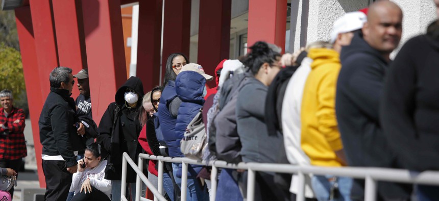 People wait in line for help with unemployment benefits at the One-Stop Career Center in Las Vegas.                                           