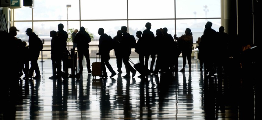 Travelers walk through the Salt Lake City International Airport Wednesday, March 17, 2021, in Salt Lake City. 