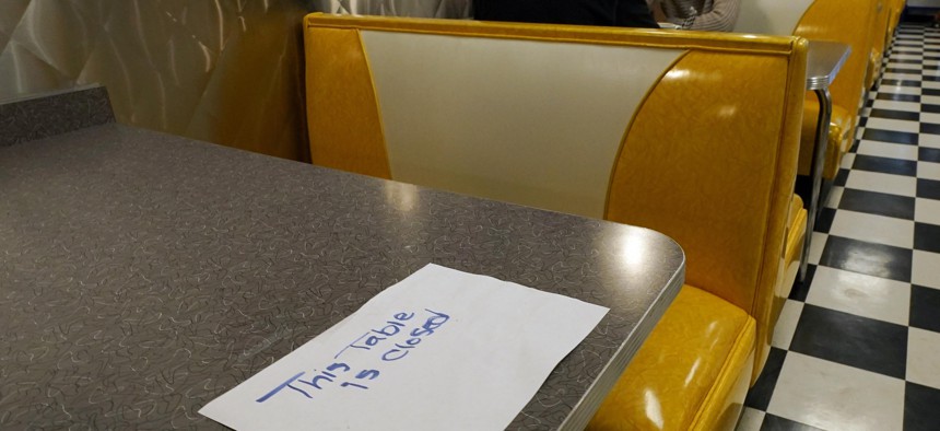 In this Nov. 17, 2020, file photo, a closed sign is posted on this table notifying diners in keeping with social distancing guidelines at Linda's Soda Bar and Grill in the Sutter County community of Yuba City, Calif. 