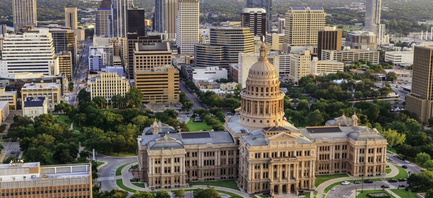 Aerial view of Capitol building in Austin the Capital of Texas with downtown Austin skyscrapers in background.