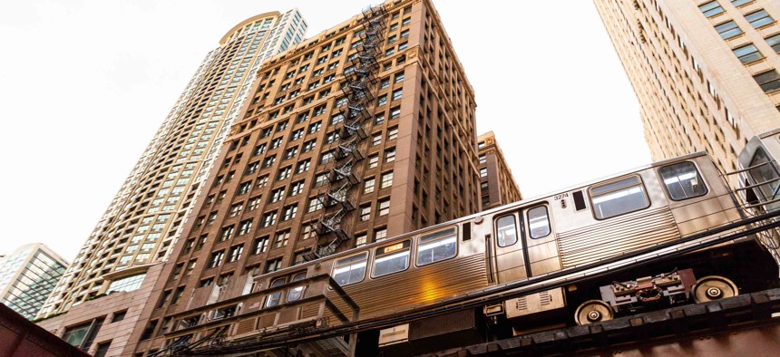 An L train passes in front of buildings in Chicago. The city is set to receive one of the biggest funding allotments among cities from a federal aid program.