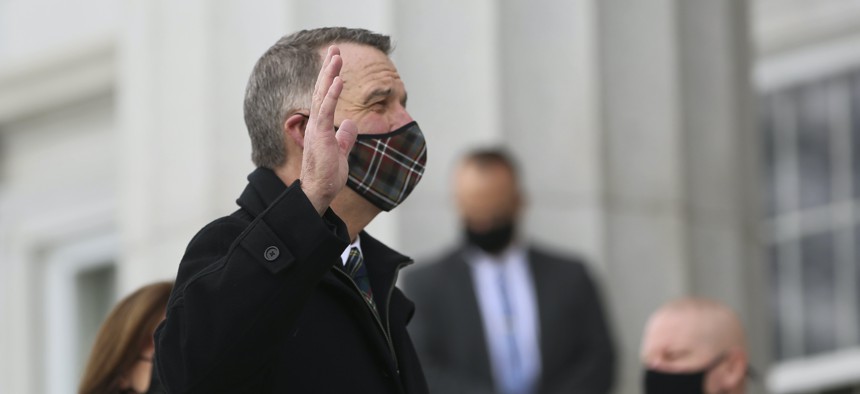 Republican Gov. Phil Scott wears a mask as he takes the Oath of Office on the steps of the Vermont Statehouse in Montpelier, Vt., beginning his third two-year term. 