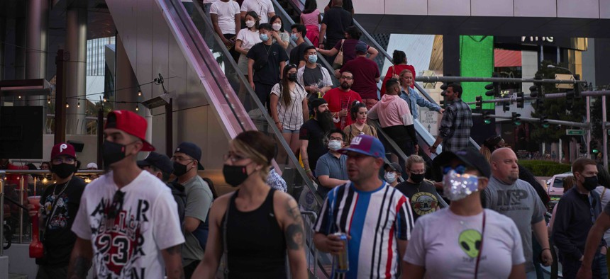 People ride an escalator along the Las Vegas Strip, Saturday, April 24, 2021, in Las Vegas. Nevada was one of the states that took a larger hit to its budget as tourism dropped during the pandemic.