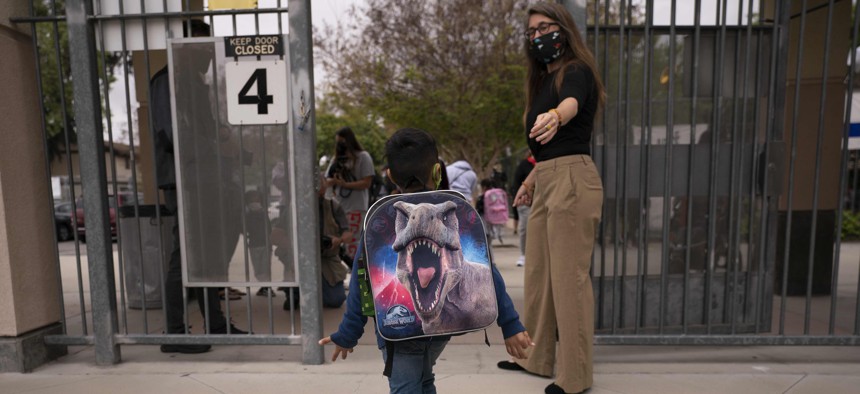 A student leaves after the first day of in-person learning at Maurice Sendak Elementary School in Los Angeles in April 2021. Education job losses account for most of the employment declines in the state and local public sector during the pandemic.