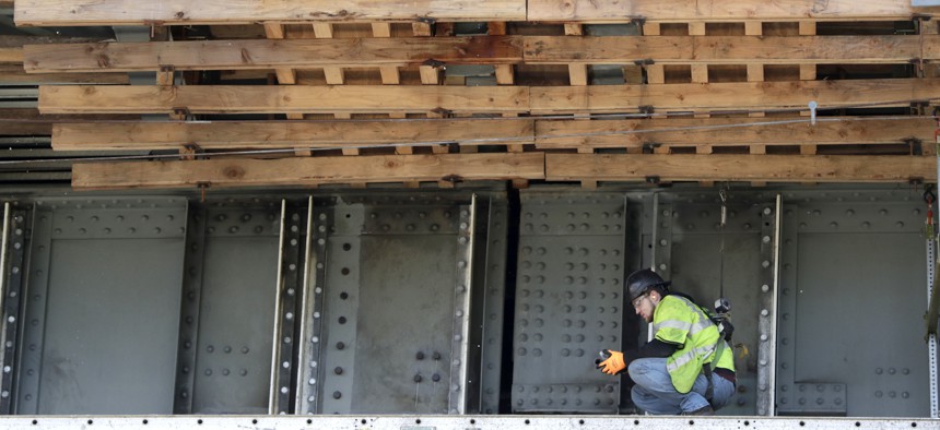 A worker labors on the beam of the Route 495 viaduct during a project to remodel the bridge which feeds into the Lincoln Tunnel in North Bergen, N.J., Tuesday, April 23, 2019.