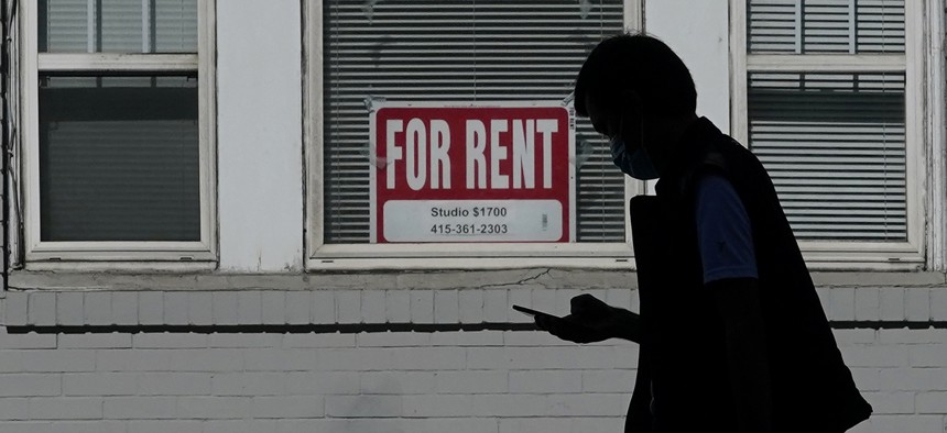 In this Oct. 20, 2020 file photo, a man walks in front of a For Rent sign in a window of a residential property in San Francisco.