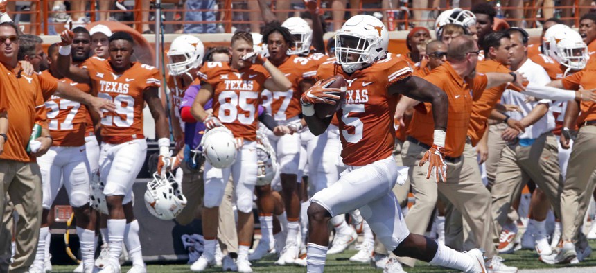 Texas defensive back runs a blocked field goal attempt back for a touchdown against Maryland during an NCAA college football game in Austin, Texas. 
