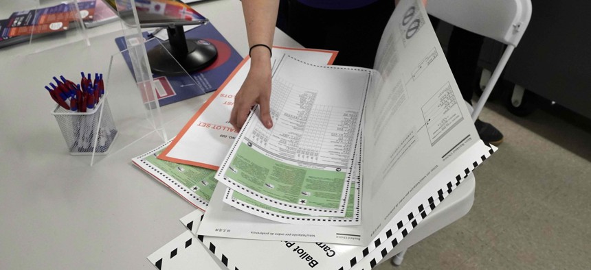 A poll worker assembles a ballot at Frank McCourt High School, in New York, Tuesday, June 22, 2021.