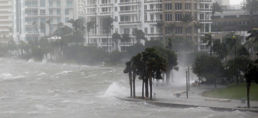 In this Sept. 10, 2017 file photo, waves crash over a seawall at the mouth of the Miami River from Biscayne Bay, Fla., as Hurricane Irma passes by in Miami.