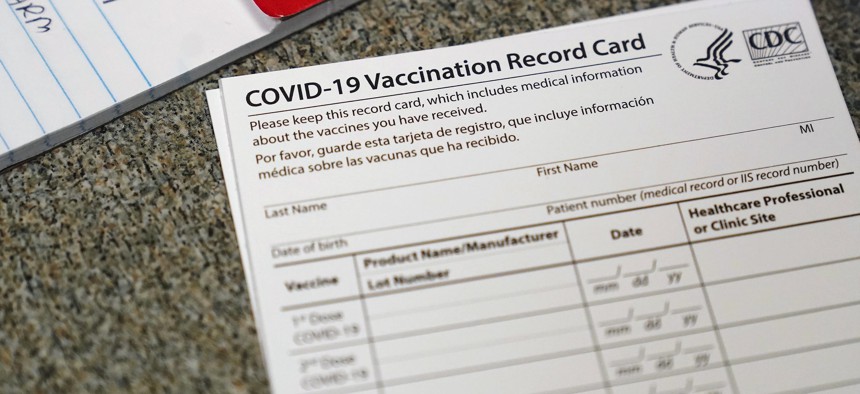 In this December 2020, file photo, a COVID-19 vaccination record card is shown at Seton Medical Center in Daly City, Calif.
