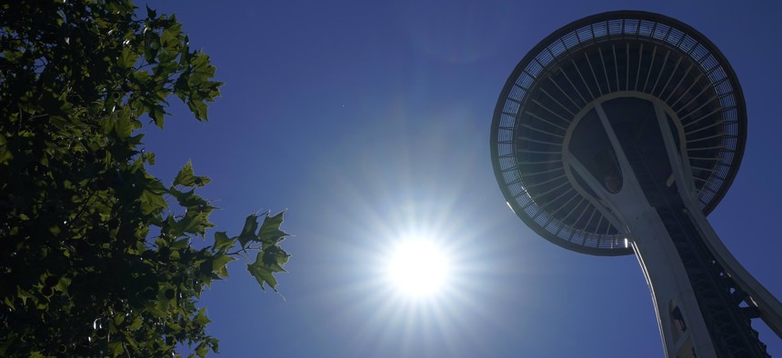 The sun shines near the Space Needle, Monday, June 28, 2021, in Seattle. Seattle and other cities broke all-time heat records over the weekend, with temperatures soaring well above 100 degrees Fahrenheit. 