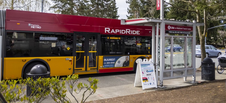 Redmond, Washington, April 2021: A Rapid Ride metro bus stopping at a bus stop.
