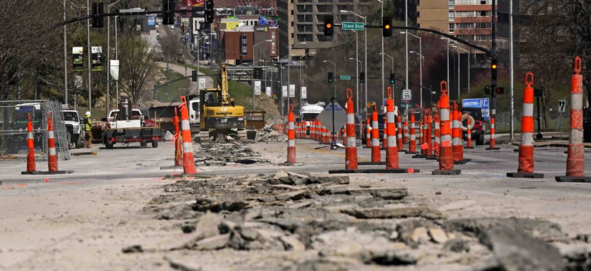 In this March 30, 2021 file photo, workers replace old water lines under Main Street as part of work to update water and sewer systems as well as prepare the road for the expansion of a street car line in Kansas City, Mo. Water infrastructure is one way communities can spend American Rescue Plan Act aid.