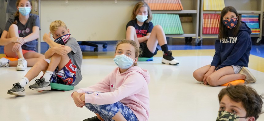 In this May 18, 2021 file photo, fifth graders wearing face masks are seated at proper social distancing during a music class at the Milton Elementary School in Rye, N.Y.