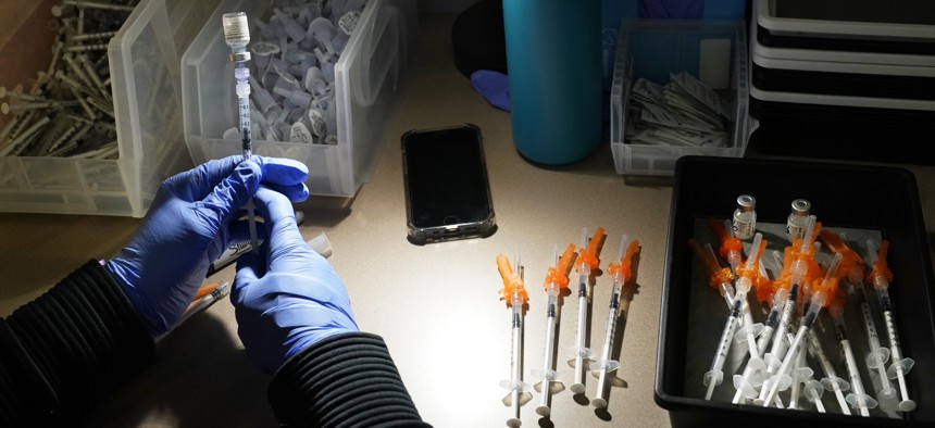 A registered nurse fills syringes with Pfizer vaccines at a COVID-19 vaccination clinic at PeaceHealth St. Joseph Medical Center Thursday, June 3, 2021, in Bellingham, Wash.
