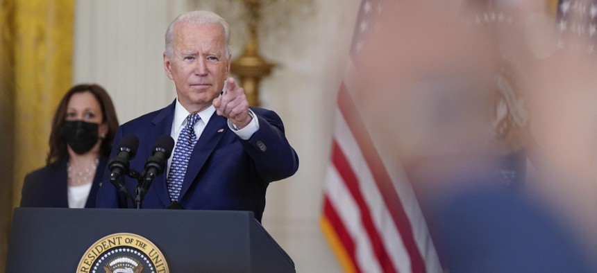 President Joe Biden gestures as he takes questions from members of the media after speaking about the bipartisan infrastructure bill from the East Room of the White House, Tuesday, Aug. 10, 2021, in Washington. Vice President Kamala Harris listens at left. 