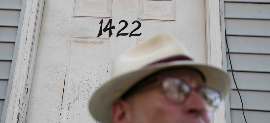 A landlord stands outside one of his rental properties, Thursday, Aug. 12, 2021, in the Queens borough of New York.