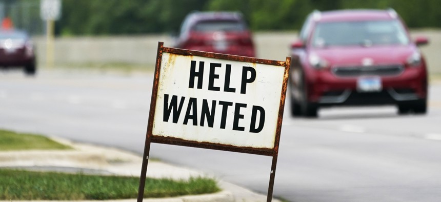 A help wanted sign is displayed at a gas station in Mount Prospect, Ill., Tuesday, July 27, 2021.