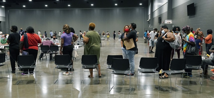 Applicants at a rental assistance fair for Jackson residents at the Mississippi Trademart, line up to be assigned the proper station in the state Fairgrounds, Saturday, July 24, 2021, in Jackson, Miss. 