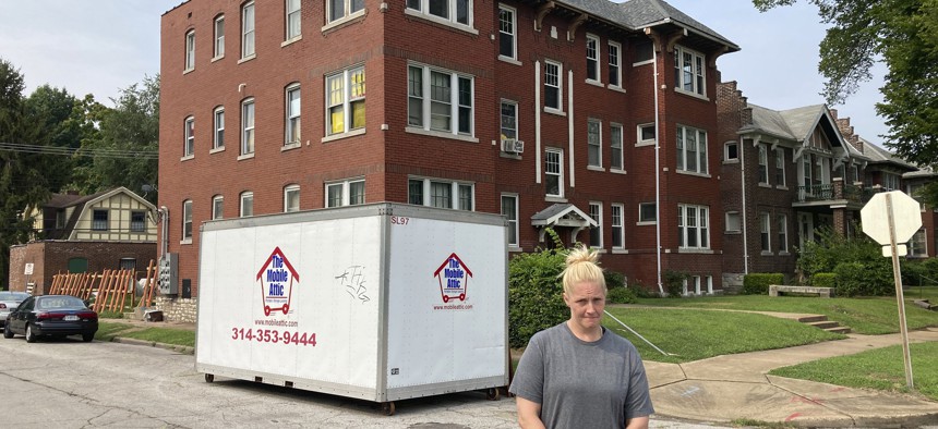 Kristen Bigogno stands in front of her St. Louis apartment on July 30, 2021. A storage trailer sits behind her. Bigogno expected to be evicted, along with her two teenage sons, soon after the federal moratorium ended. She says they have no place to go and may face homelessness.