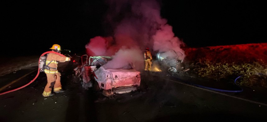 Santa Barbara County Fire crews extinguish fires from a two vehicle, triple fatal accident that happened on Highway US 101 north of Goleta, Calif., early Wednesday, Aug. 25, 2021.