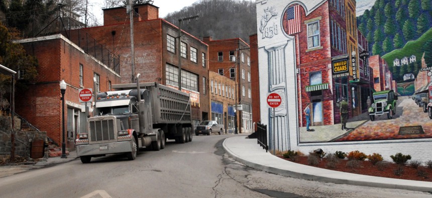  In this Feb. 9, 2011, file photo, a coal truck drives out of downtown Welch, W.Va. The Economic Development Administration makes grants to help struggling communities.