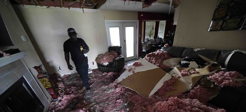 Michael Lathers walks past the collapsed ceiling in his flooded home in the aftermath of Hurricane Ida in LaPlace, La., Tuesday, Sept. 7, 2021. 