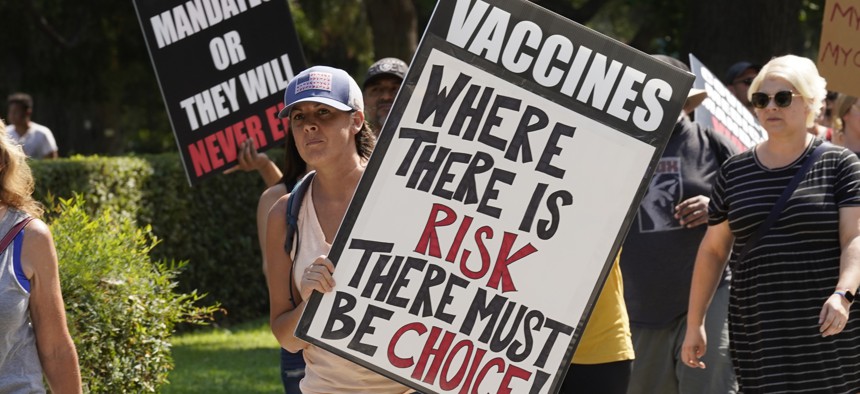 Protesters opposing vaccine mandates march past the Capitol in Sacramento, Calif., Wednesday, Sept. 8, 2021.