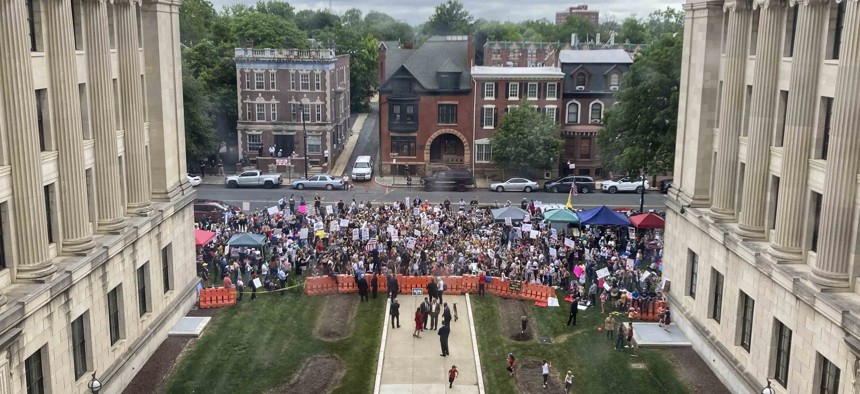 Rallygoers carry signs that say "Unmask our kids" and chanting "kill the bill," opposing a bill that would end the public health emergency stemming from the COVID-19 outbreak, Thursday, June 3, 2021, in Trenton, N.J. 