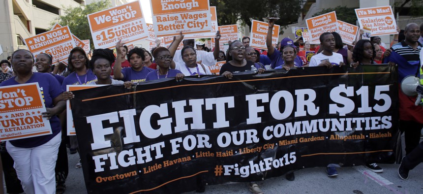 In this April 15, 2015, file photo, protesters march in support of raising the minimum wage to $15 an hour as part of an expanding national movement known as Fight for 15, in Miami. 