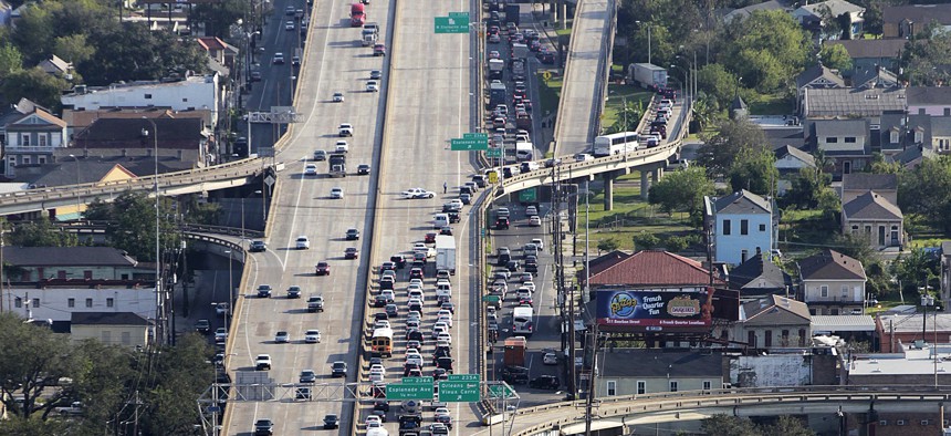 In this Sept. 19, 2012, file photo, traffic is diverted down the Esplanade Avenue exit following an accident on the elevated Interstate 10 expressway that runs above Claiborne Avenue in New Orleans. The expressway was built directly on top of Claiborne Avenue in the late 1960s — ripping up the oak trees and tearing apart a street sometimes called the “Main Street of Black New Orleans."