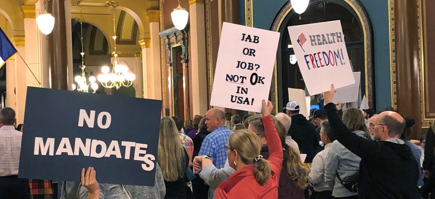 Protesters gather at the Iowa Capitol in Des Moines, Iowa, on Thursday Oct. 28, 2021, to push the Iowa Legislature to pass a bill that would prohibit vaccine mandates from being imposed on employees in Iowa. 