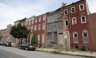 Boarded up buildings on a street in Baltimore, during 2019, in an area that is designated as an opportunity zone.