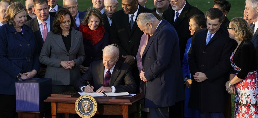  President Joe Biden signs the $1.2 trillion bipartisan infrastructure bill into law during a ceremony on the South Lawn of the White House in Washington on Nov. 15, 2021.