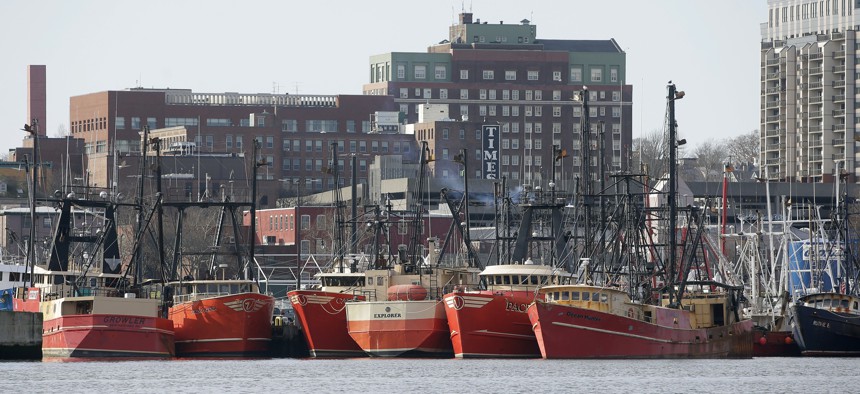 In this Wednesday, Dec. 6, 2017 photo fishing vessels are docked in New Bedford Harbor, in New Bedford, Mass. 