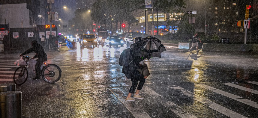 People travel through a torrential downpour caused from the remnants of Hurricane Ida, near Columbus Circle on Sept. 1, 2021. 