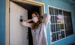 A participant in the Project Roomkey program in California, outside a motel room in April 2020.
