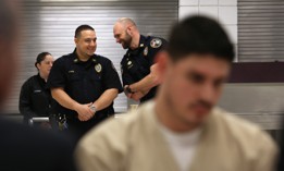 Prison guards talking at the Cybulski Community Reintegration Center in Enfield, Connecticut. Corrections agencies in many states have had trouble filling positions, which often pay less than private sector jobs.