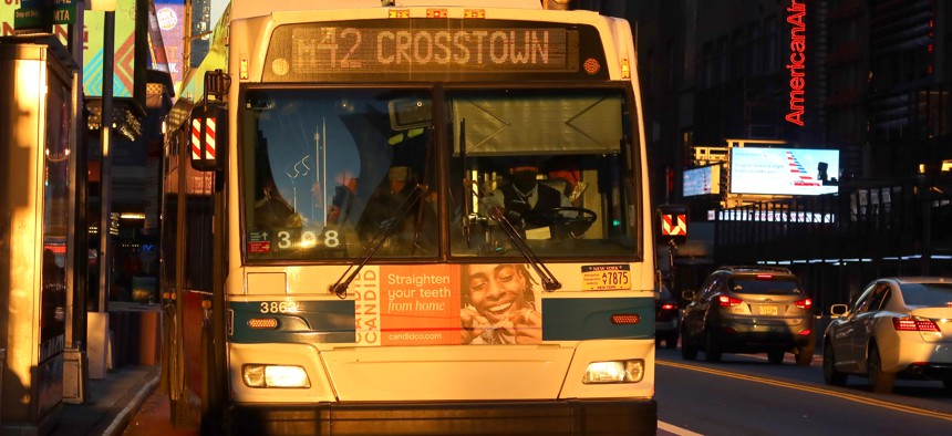 An MTA bus drives along 42nd Street as the sun rises on November 18, 2021, in New York City. 
