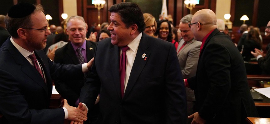  Illinois Gov. J.B. Pritzker is congratulated by lawmakers after delivering his first budget address to a joint session of the lllinois House and Senate in 2019