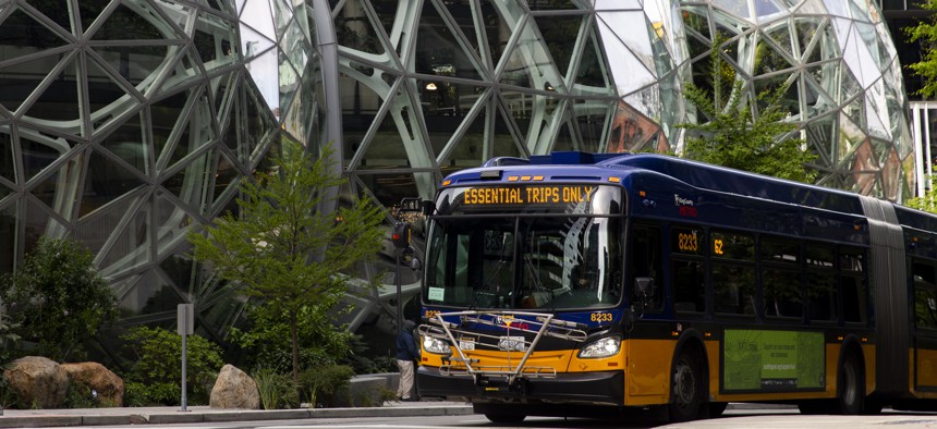 A King County Metro bus for essential trips only passes by The Spheres at the Amazon campus on April 30, 2020 in Seattle.