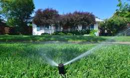 An automated sprinkler waters grass in front of homes in Alhambra, California on April 27, a day after Southern California declared a water shortage emergency with unprecedented new restrictions on outdoor watering for millions of people living in Los Angeles, San Bernardino and Ventura counties. 