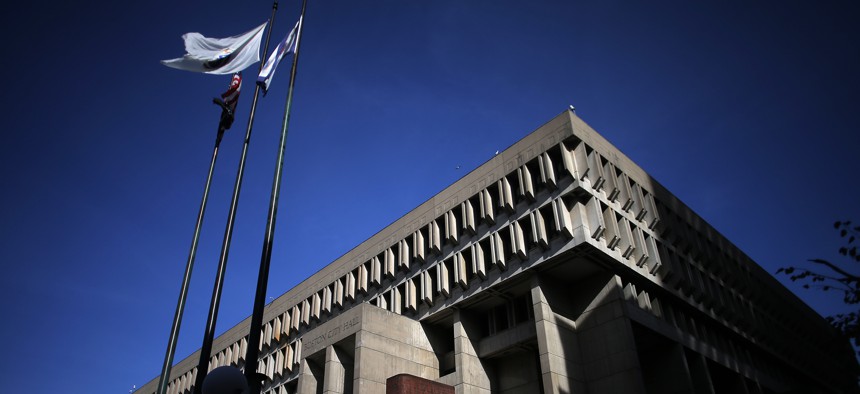 Flags fly above Boston City Hall on Nov. 11, 2021.