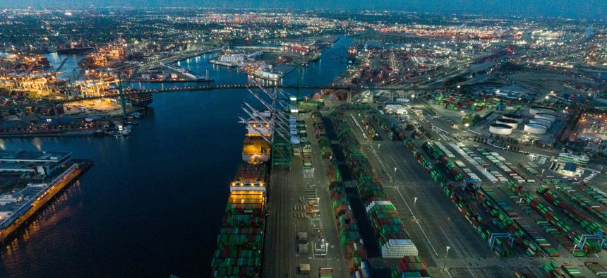  An aerial view of shipping containers sitting stacked at the Port of Los Angeles at night in April 2022 in San Pedro, California.