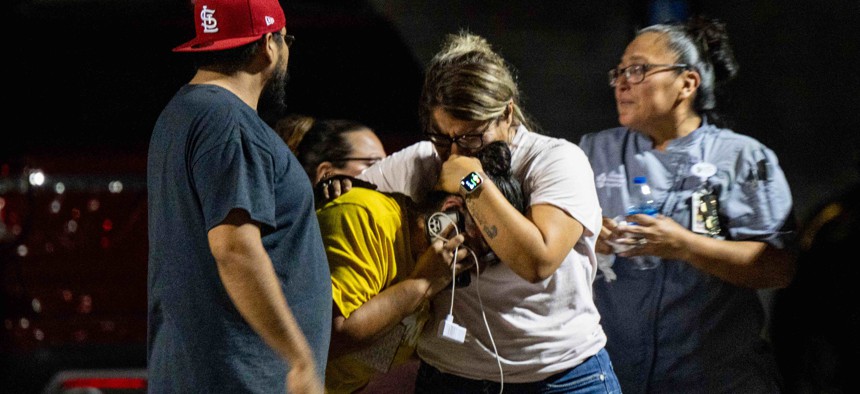 A family grieves outside of the SSGT Willie de Leon Civic Center following the mass shooting at Robb Elementary School on May 24, 2022 in Uvalde, Texas. 