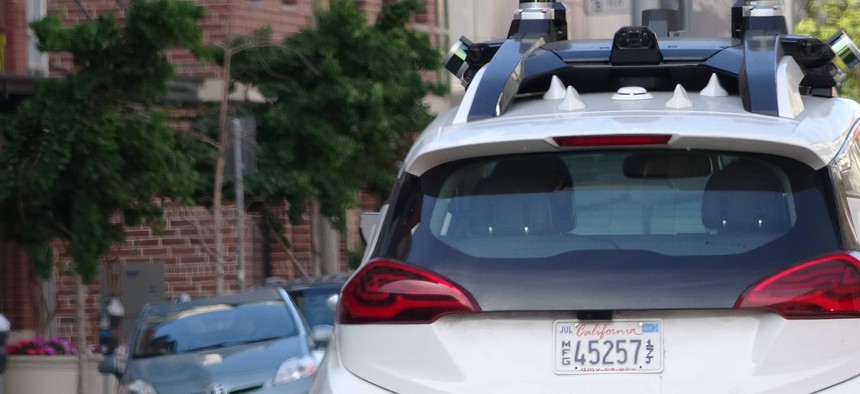 Close-up view from behind of General Motors Cruise self-driving car in the South of Market (SoMA) neighborhood of San Francisco, with Lidar and other sensors visible.
