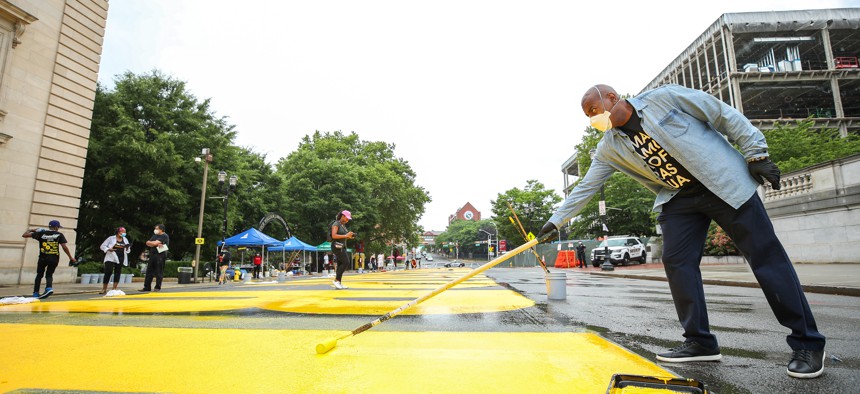 Mayor Ras Baraka paints during the "All Black Lives Matter" Community Painting Day on June 27, 2020 in Newark, New Jersey. 