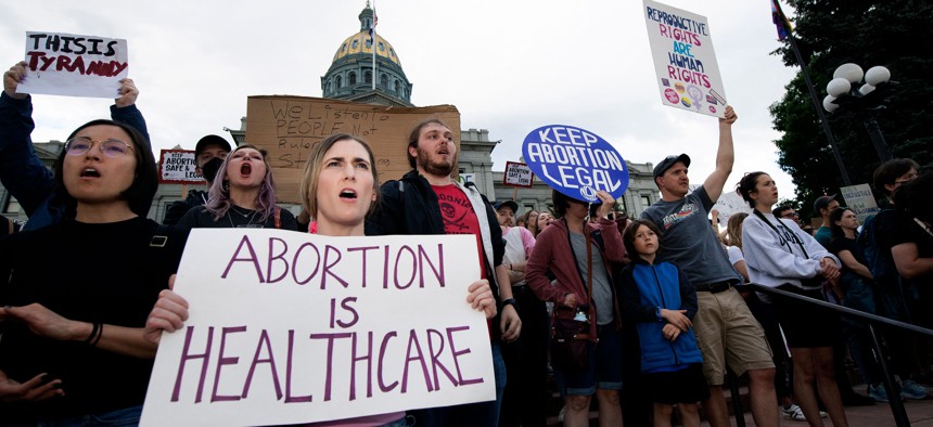 Abortion rights activists protest in front of the Colorado State Capital after the overturning of Roe vs. Wade.