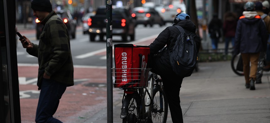 A food delivery guy with bicycle is seen at the Times Square in New York City.