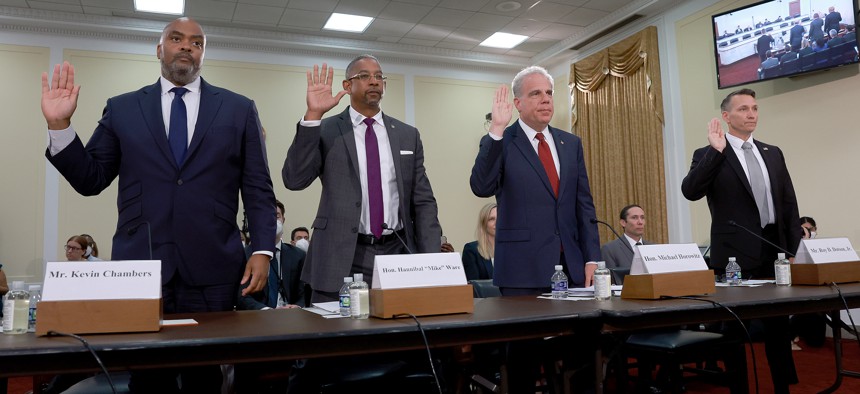 (L-R) Kevin Chambers, Director for COVID-19 Fraud Enforcement, Department of Justice; Hannibal "Mike" Ware, Inspector General, Small Business Administration; Michael Horowitz, Chair, Pandemic Response Accountability Committee; and Roy D. Dotson Jr., Acting Special Agent in Charge, National Pandemic Fraud Recovery Coordinator, United States Secret Service; are sworn in to testify during a hybrid hearing held by the House Select Subcommittee on the Coronavirus Crisis in the Rayburn House Office Building on June 14, 2022 in Washington, D.C.